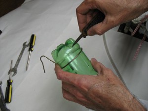 Cut vent hole in soda bottle