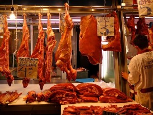 Lambs hanging in the Athens Central Market; the scene cannot have changed much in the last seven decades. It’s still noisy, gory, chaotic, and exciting.