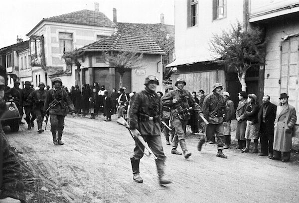 A squad of German soldiers passing through a Greek village, during the Occupation. (Photo by The Associated Press.)