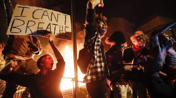 Protestors demonstrate with an "I can't breathe" sign at Minneapolis’s 3rd Police Precinct. (Photo: AP.)