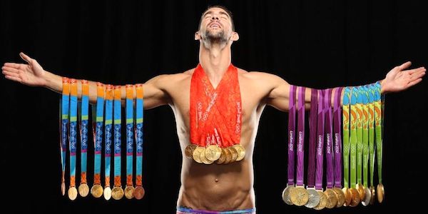 Michael Phelps, draped with all his medals (23 of them gold). (Sports Illustrated.)