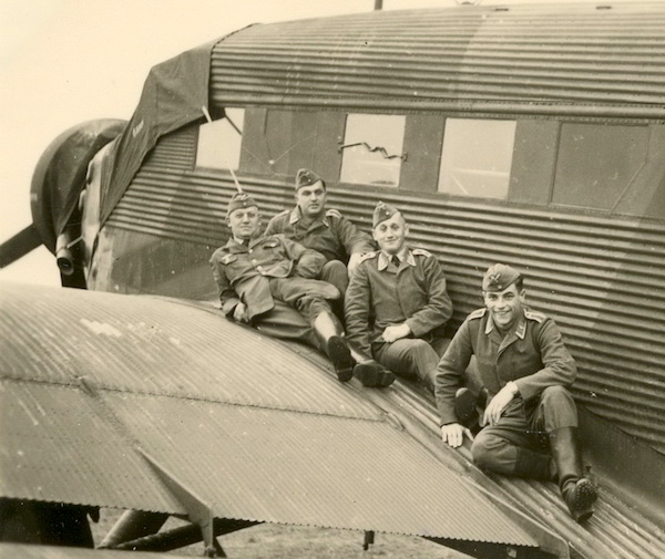 “They do not spend much time imagining past or future.” Group on wing of a Ju-52 transport.