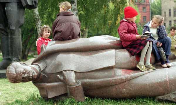 Moscow students atop toppled statue of Stalin.