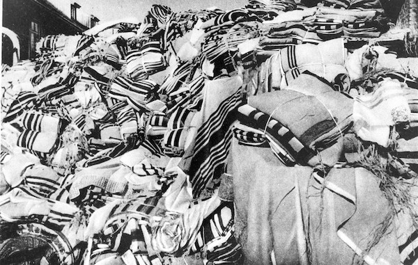 Eisiminger Prayer shawls (tallesim, tallitot) confiscated from arriving prisoners; stored in a warehouse at Auschwitz. (Photo: United States Holocaust Memorial Museum.