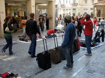 African immigrants peddling luggage in Athens.