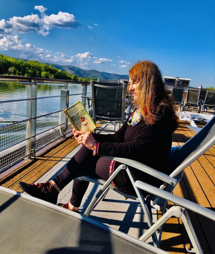 The author enjoying Austen’s Persuasion on the Rhone River, France.