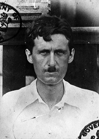 A passport photo showing George Orwell during his time in Burma. Image via Wikimedia Commons.