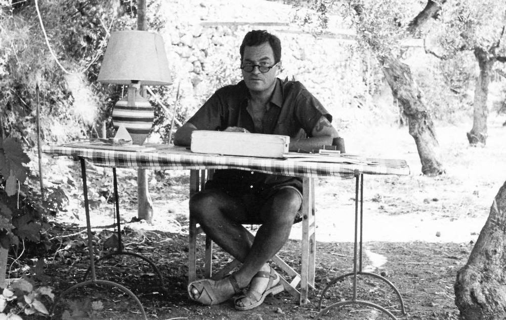 Patrick Leigh Fermor writing in his garden at Kardamyli, Greece. (Photo: Estate of Patrick Leigh Fermor.)