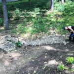 The author, and sculptor, at work on her French drain. (Photo: E. Boleman-Herring.)