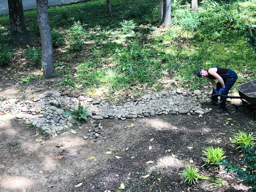 The author, and sculptor, at work on her French drain. (Photo: E. Boleman-Herring.)